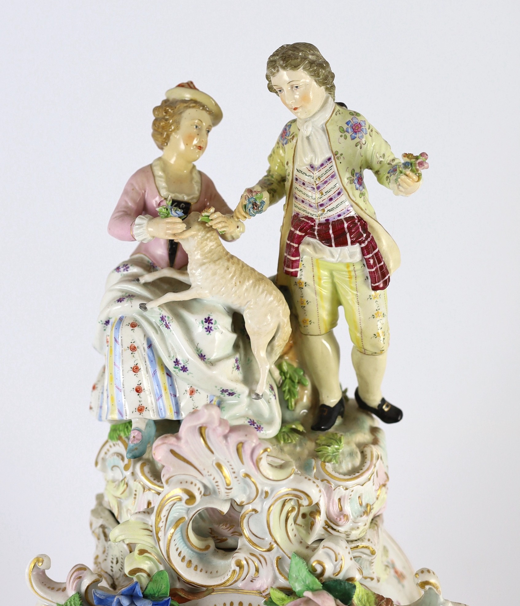 An impressive German porcelain floral encrusted figural mantel clock, late 19th century, Total height 65 cm